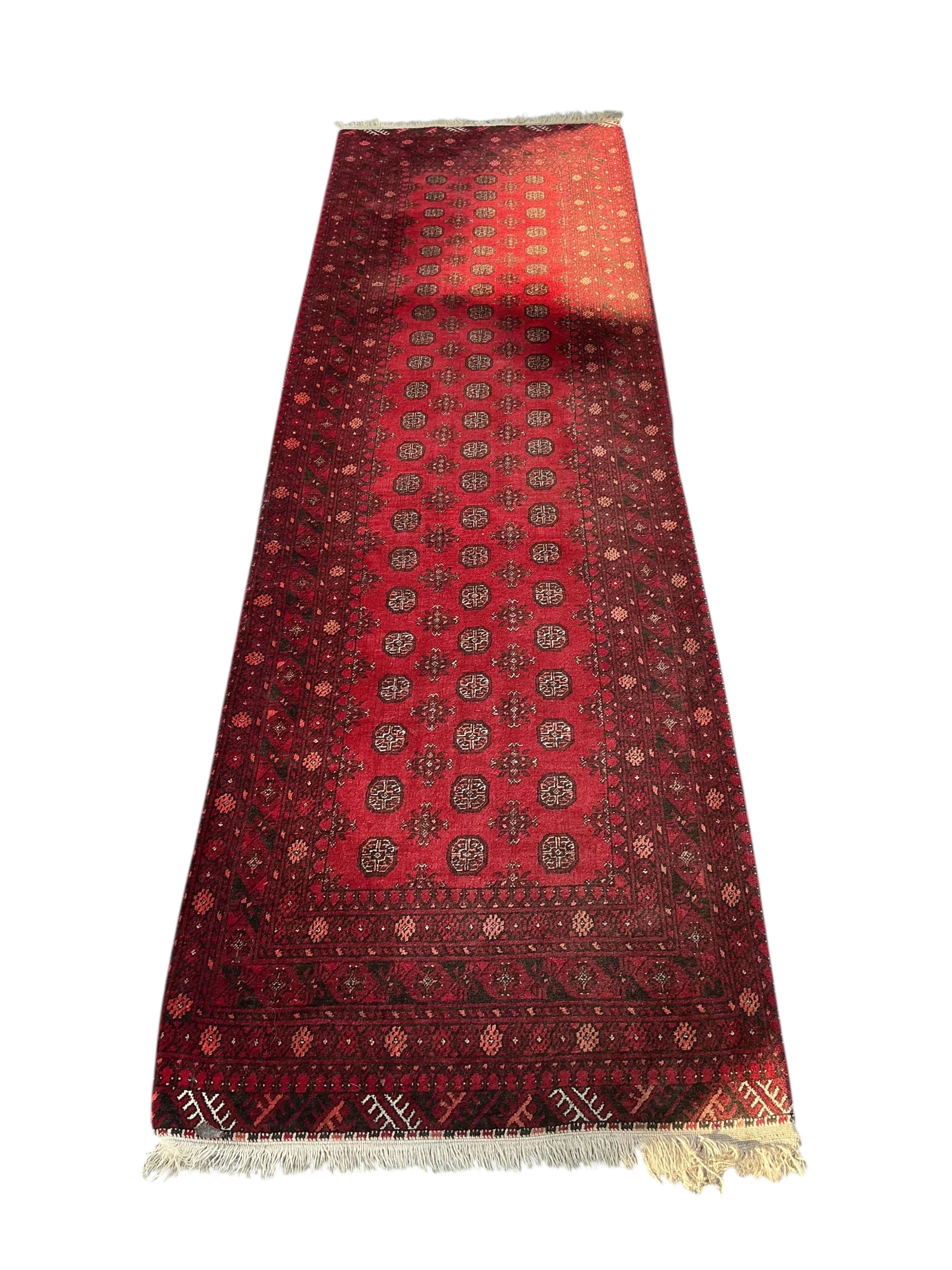 A Bokhara red ground runner, 290 x 80cm